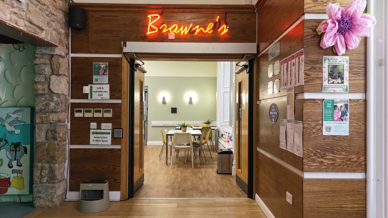The entrance to Browne's Cafe with light up works saying Browne's.