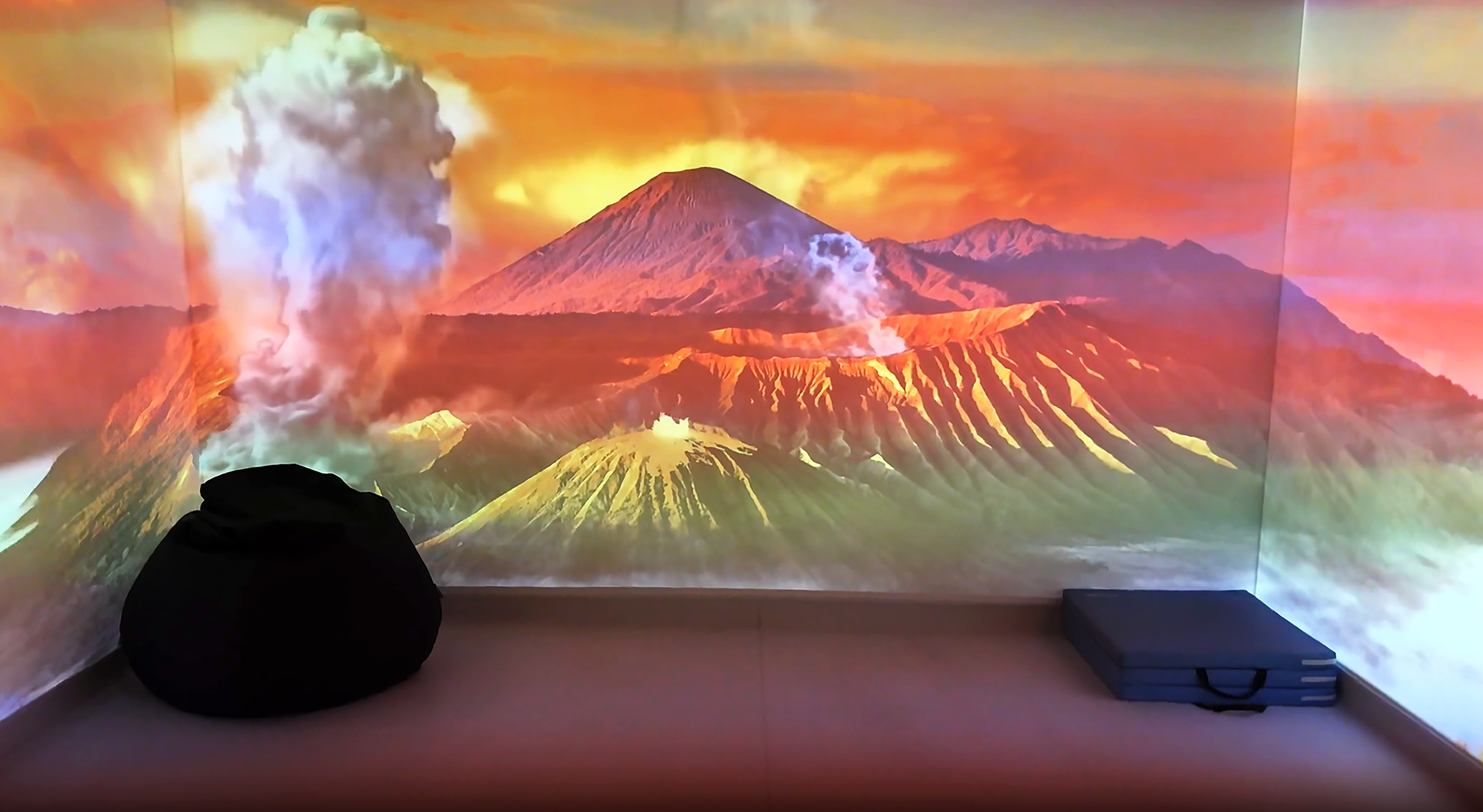 immersive room with a volcano picture on the wall and floor