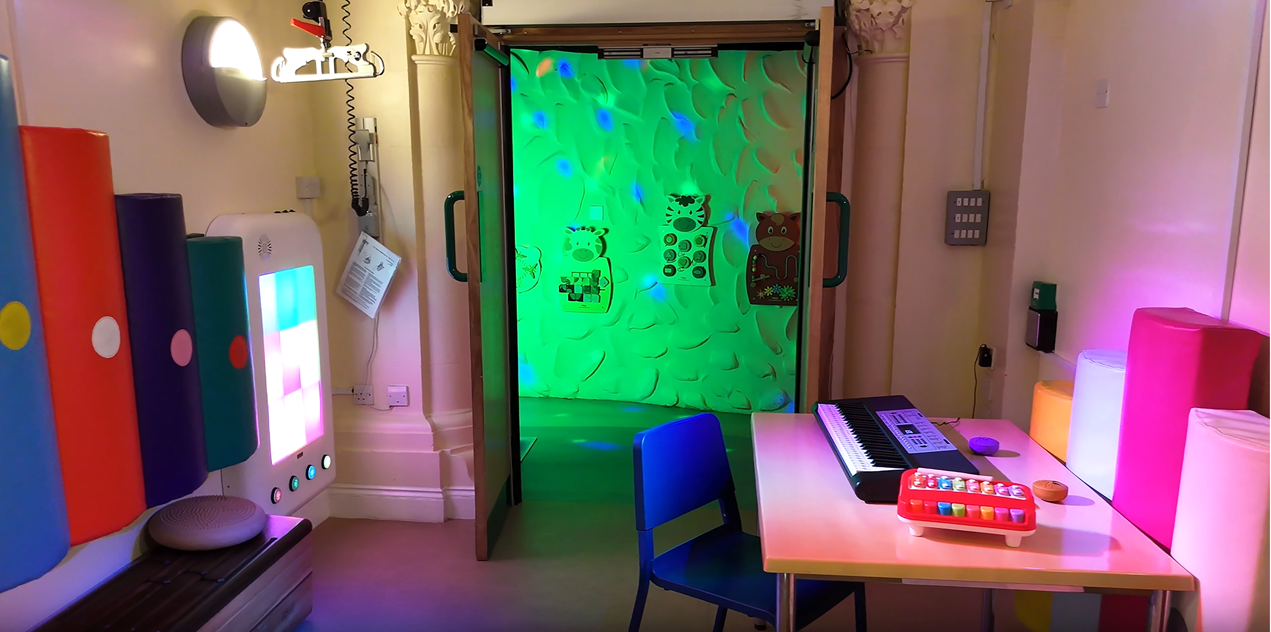 Music room with desk, lights and instruments on the walls