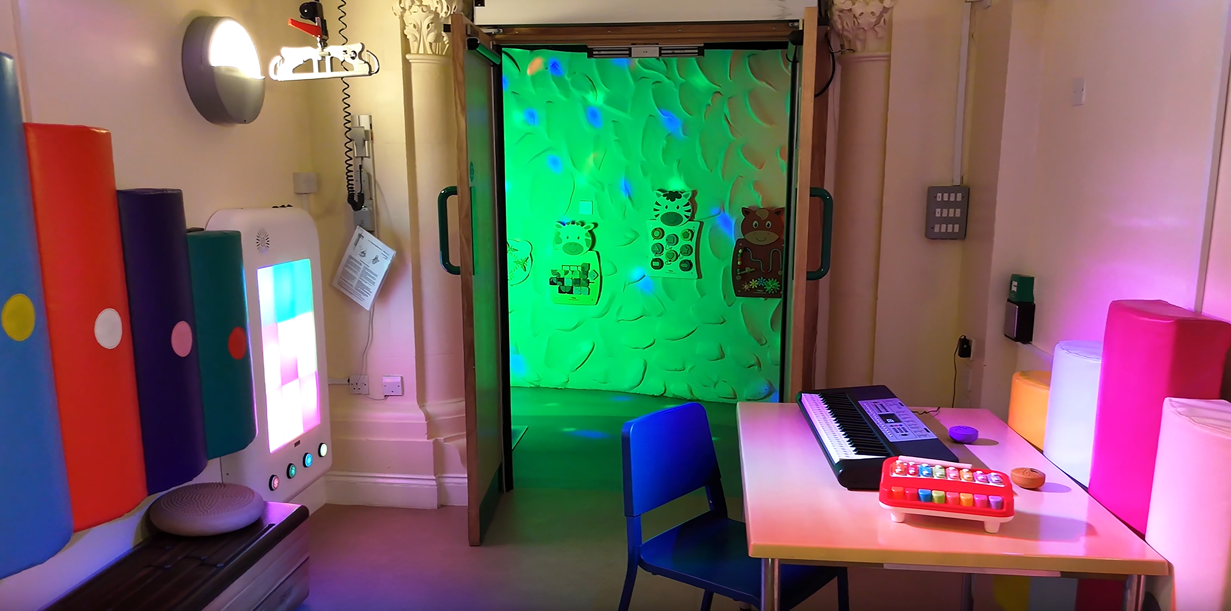 Music room with piano and desk with sensory walls